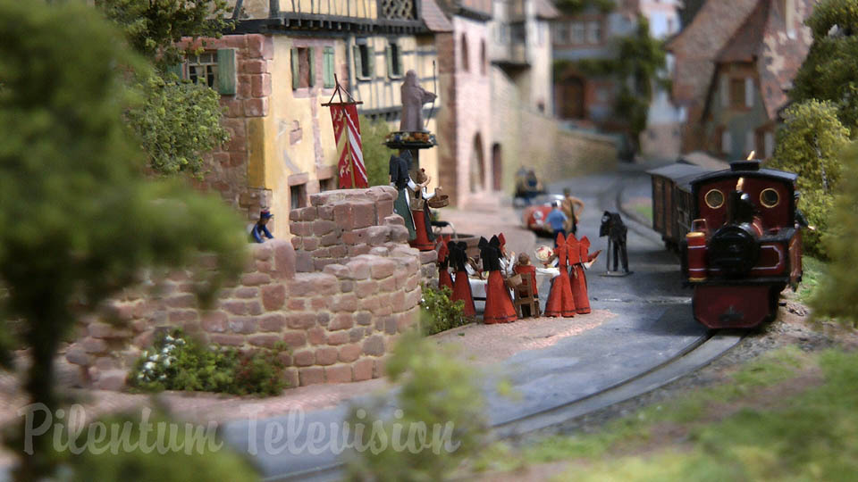 The little steam train inside a realistic built model railway landscape in HO scale