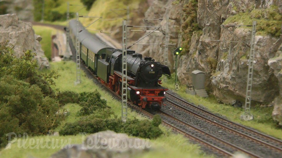 Model railroad layout in HO scale with steam locomotives and steam trains